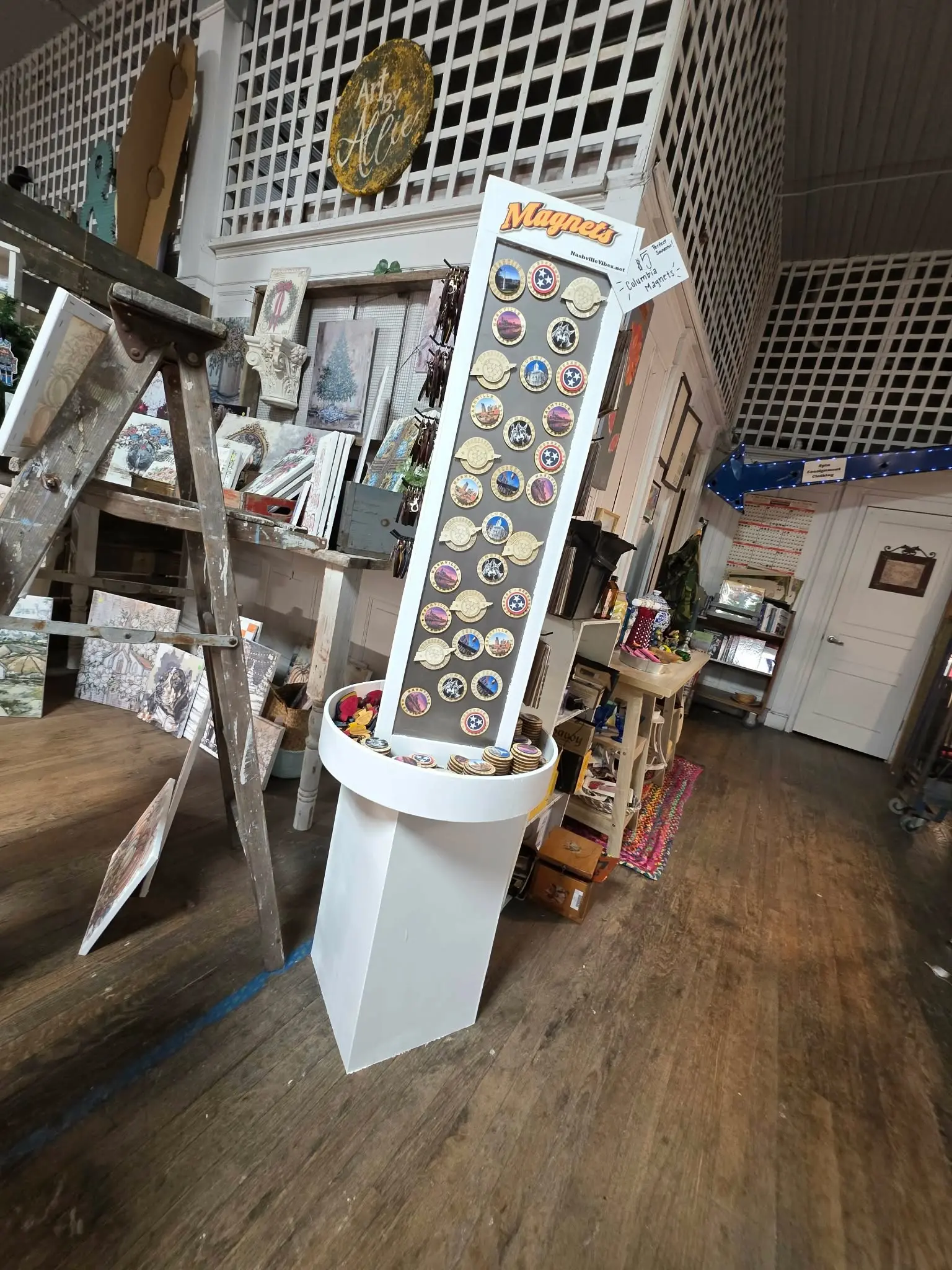 Hometown Vibes floor display filled with round Nashville and Columbia magnets